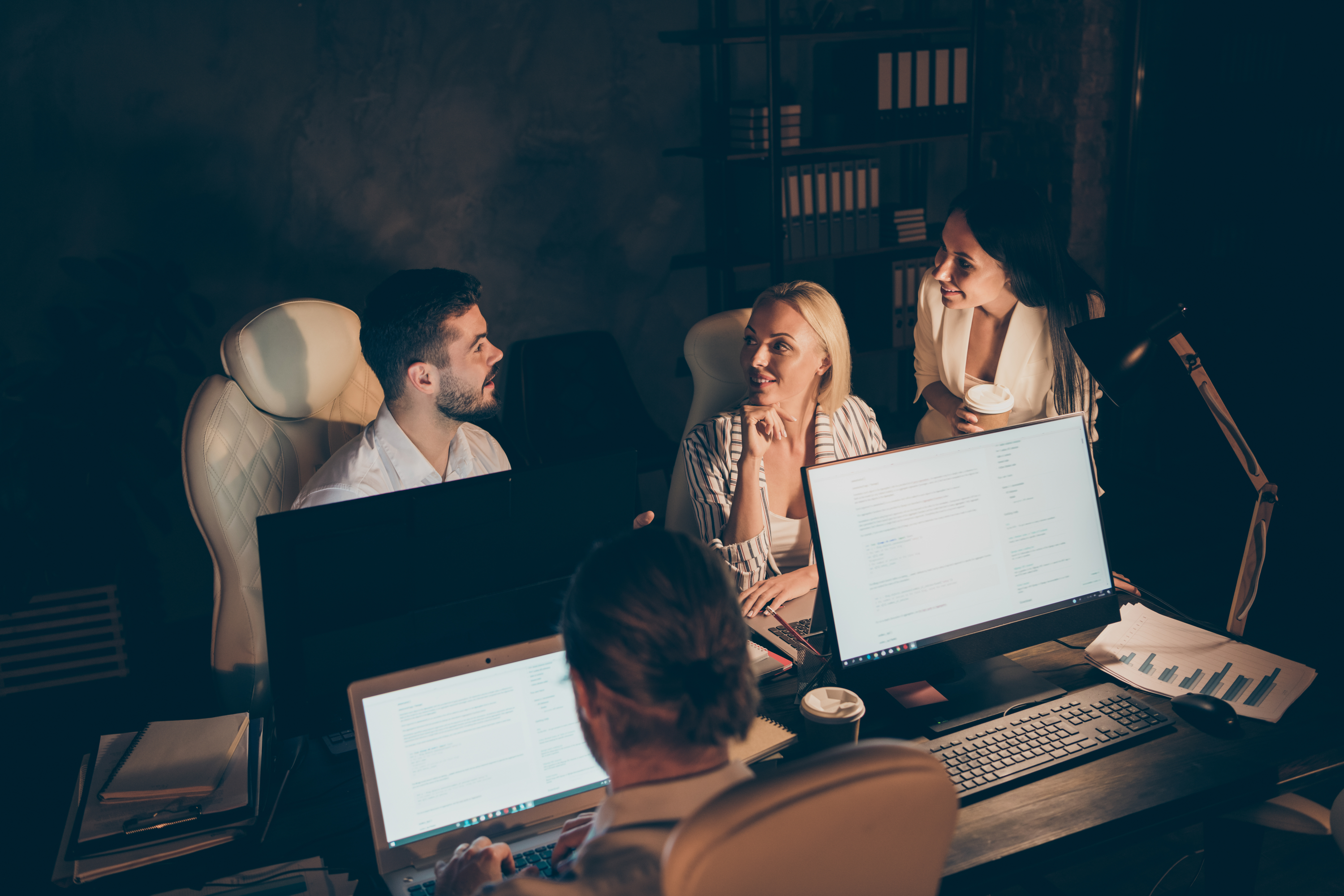 Four nice attractive hardworking cheerful people leaders partners top executive managers entrepreneurs developing department solving tech issue meeting deadline at late night work place station